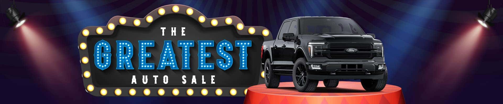 Black truck spotlighted beside "The Greatest Auto Sale" marquee sign in shimmering lights.