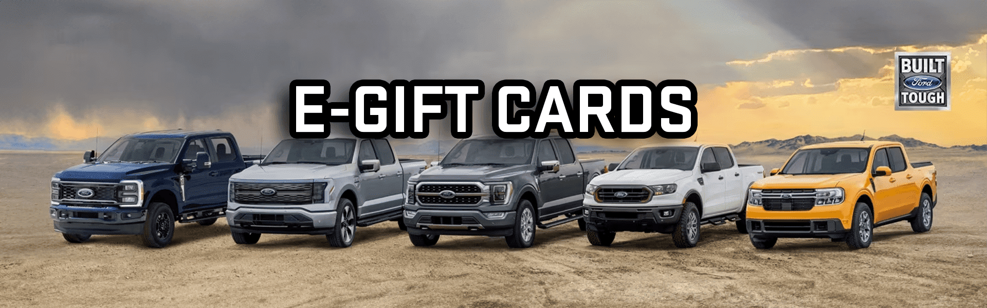 Ford trucks lineup with "E-Gift Cards" text and "Built Ford Tough" emblem in a desert setting.
